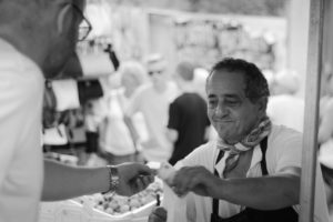 Man selling olives in street market, Spain