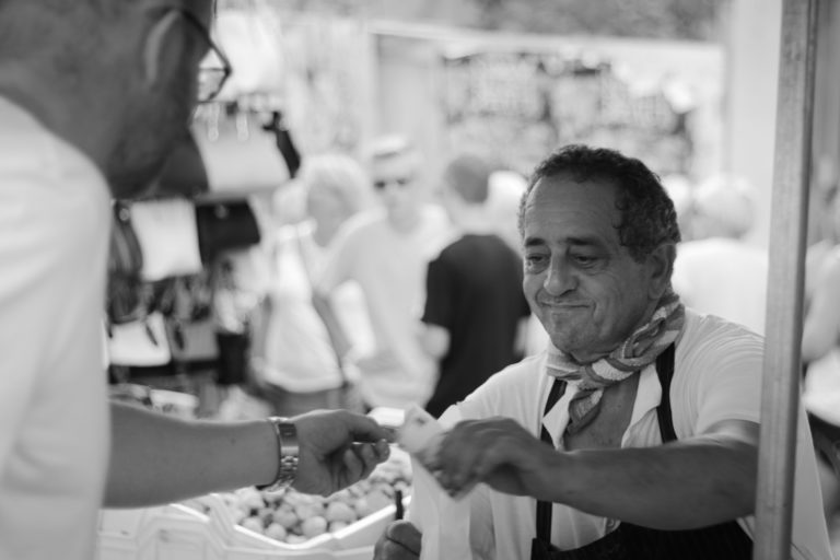 Man selling olives in street market, Spain
