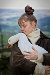 Young woman holding goose