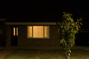 Hunstanton bungalow at night with orange glow from living room window