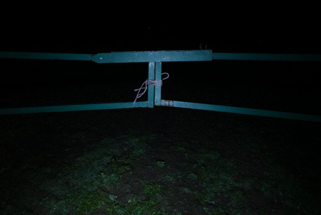 Negative Space - farm gate at night