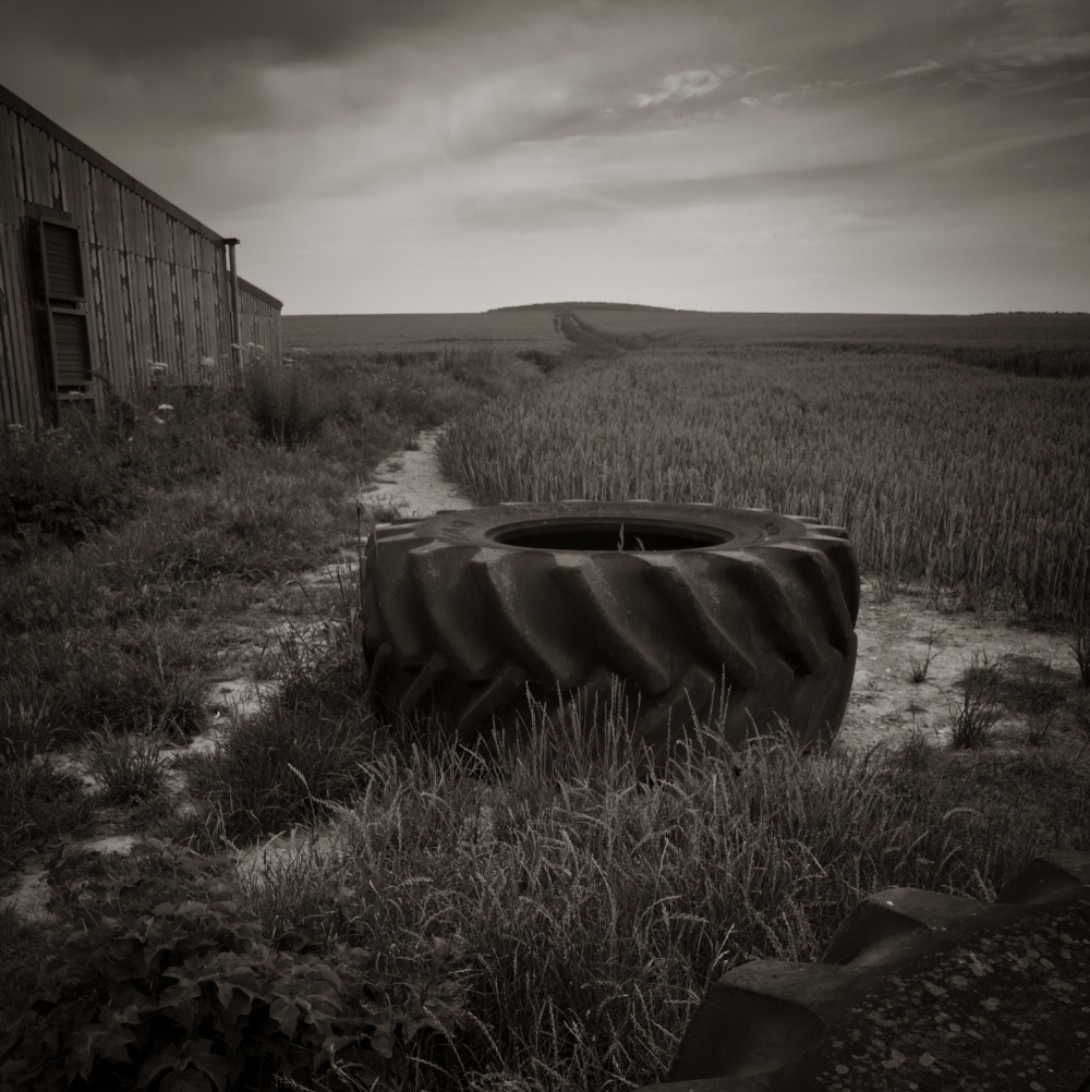 Old tractor tyre in farm yard on the Isle of Wight