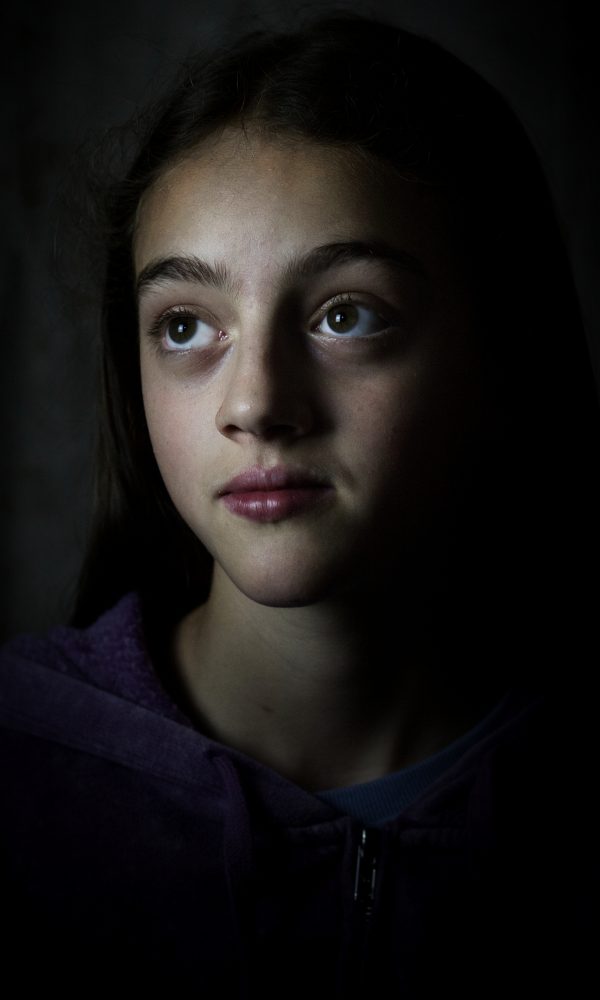 Portrait of young woman with big eyes looking upward